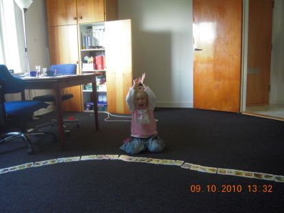Niece laying cards on the floor at my house